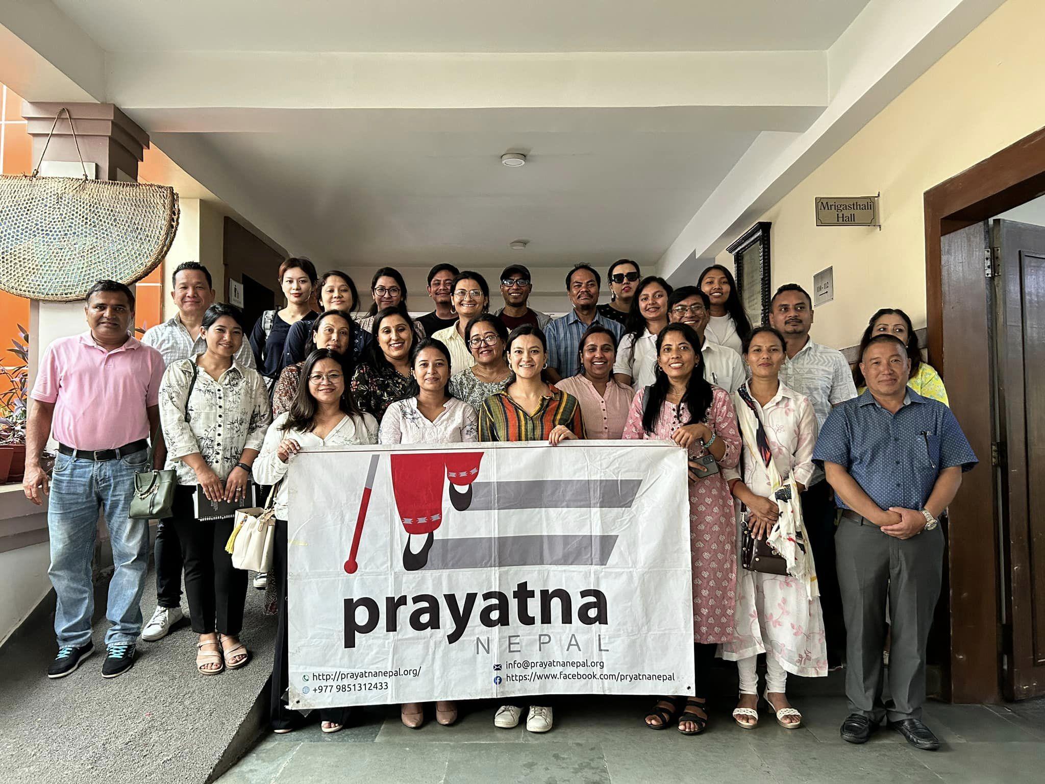 Group photo after the workshop all standing together holding the Prayatna Nepal's banner.