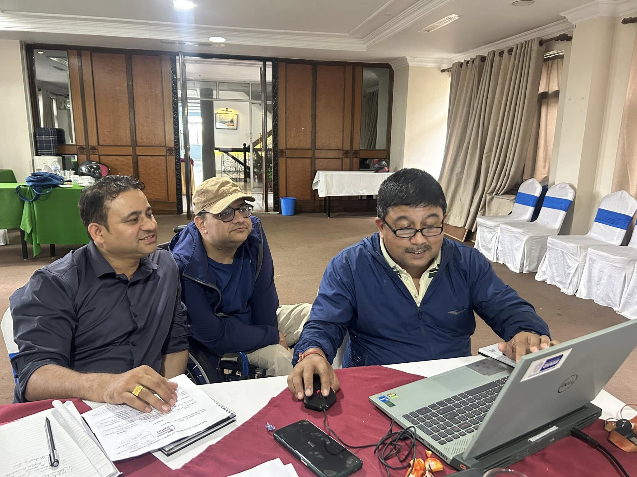 Participants engaging practical session while seeking support from facilitator