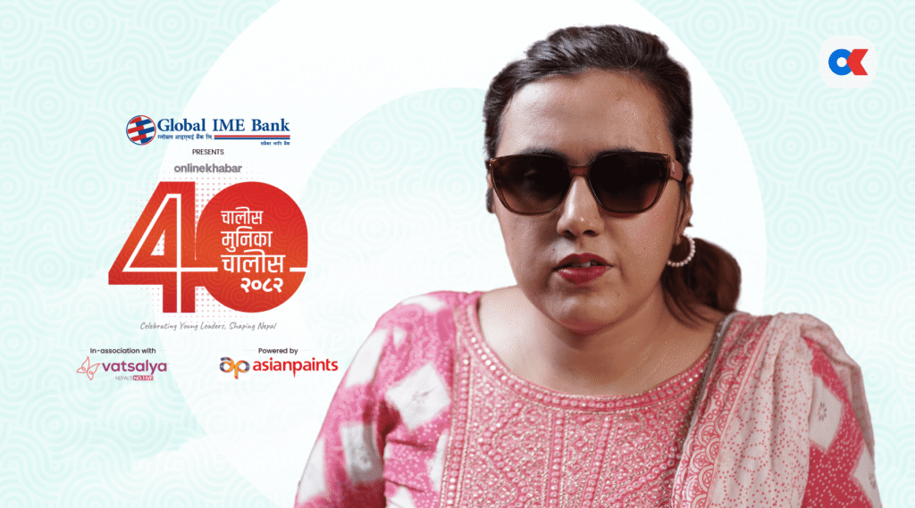 A medium shot of Sarita Lamichhane, a woman with short dark hair wearing large brown sunglasses and a pink and white patterned kurta. Behind her is a graphic with the "Global IME Bank" and "Online Khabar" logos, the number "40" in a stylized red and black design, and text in Nepali.