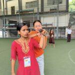 Two women practice self-defense techniques with white canes.